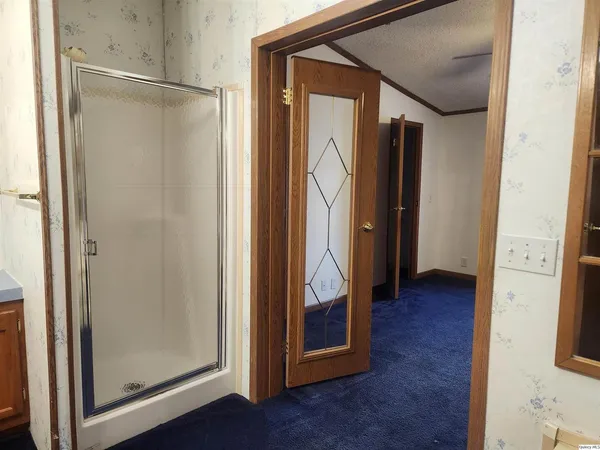 a view of a hallway with wooden floor and entryway