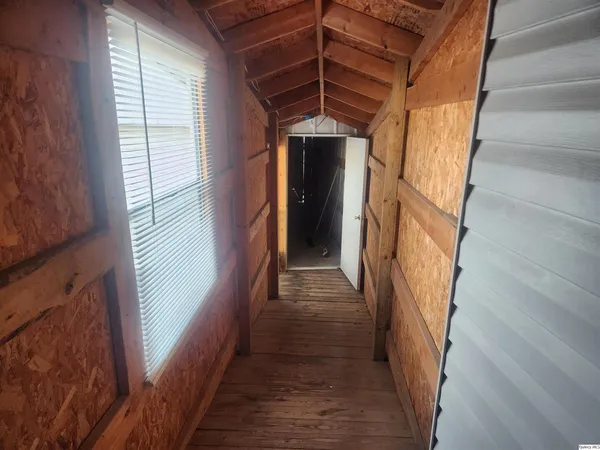 a view of a hallway with wooden floors and stairs