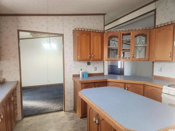 a kitchen with stainless steel appliances granite countertop a sink and a refrigerator