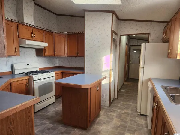 a kitchen that has a sink and a stove in it