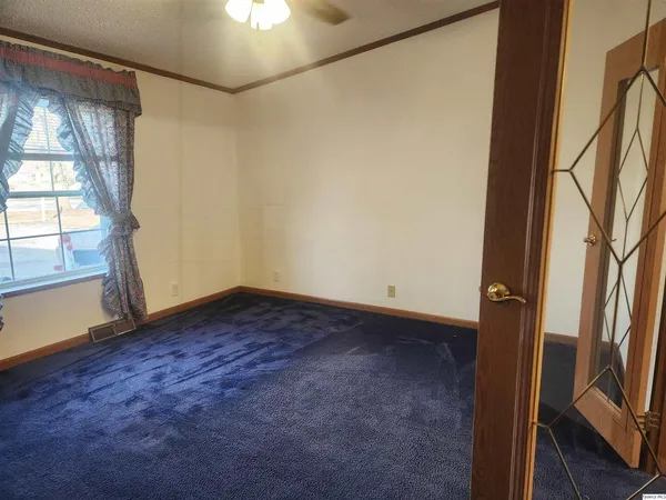 an empty room with windows and entrance