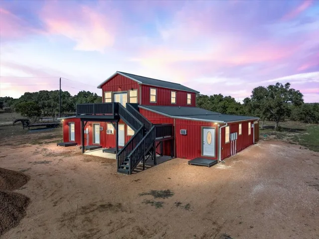 a view of a wooden house with a yard
