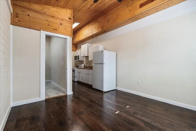a view of a kitchen with wooden floor