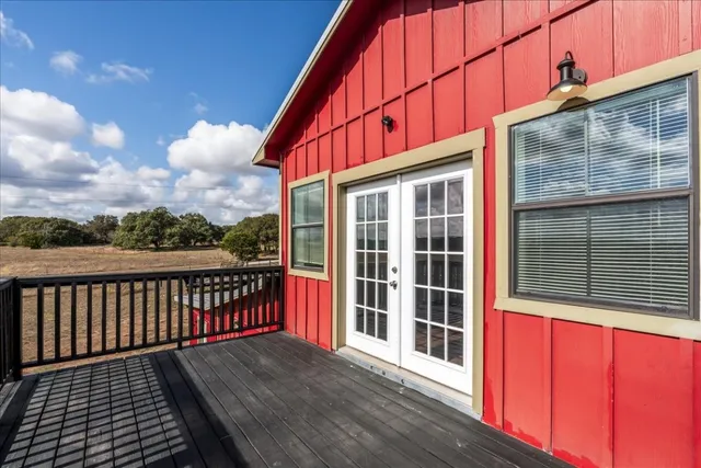 a balcony with wooden floor and city view