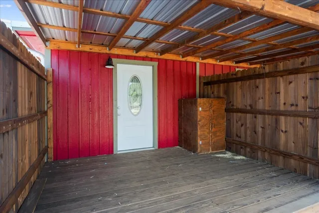 a view of an empty room with wooden walls