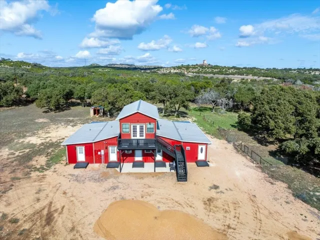 an aerial view of a house with a yard
