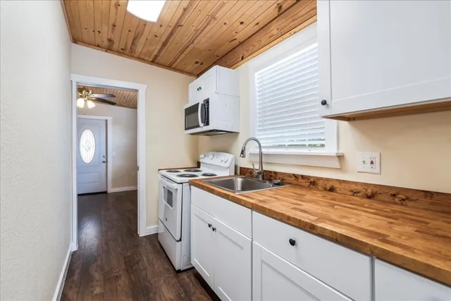 a kitchen with granite countertop a sink and a stove