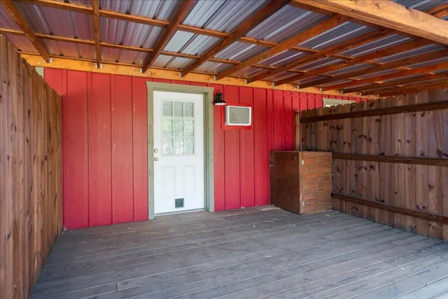 a view of empty room with wooden walls