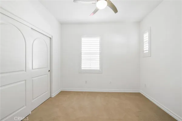 a bathroom with a granite countertop sink two mirror and a shower