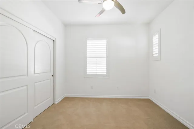a bathroom with a granite countertop sink two mirror and a shower