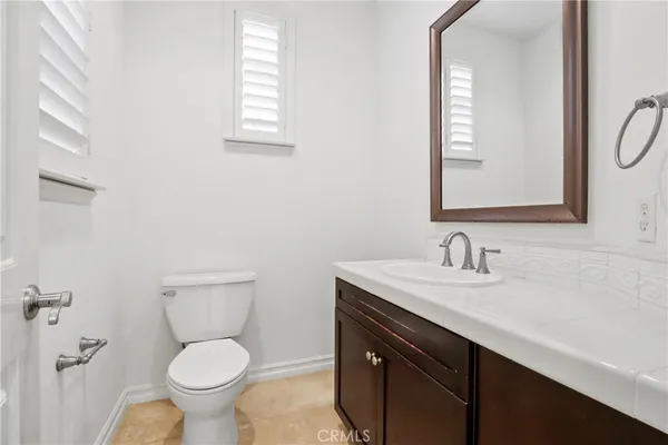 a view of empty room with fan and windows