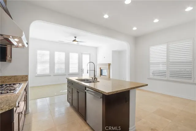 a kitchen with sink stove and cabinets