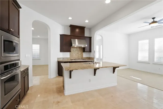 a kitchen with stainless steel appliances granite countertop a stove and a sink
