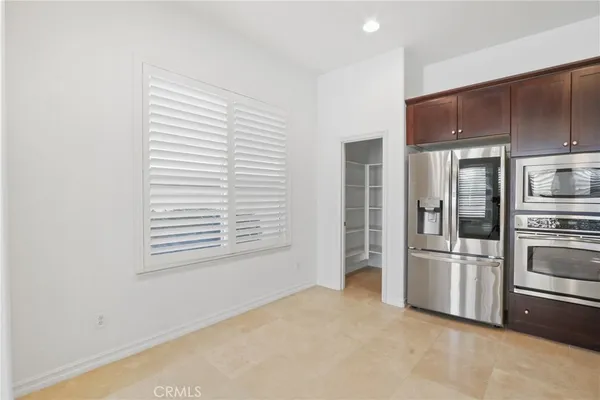 a kitchen with stainless steel appliances a refrigerator and a stove top oven