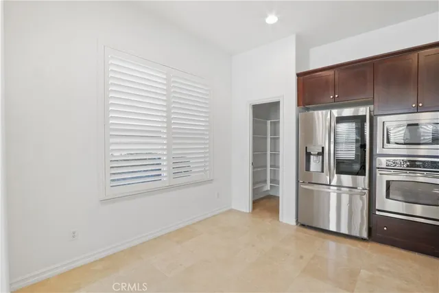 a kitchen with stainless steel appliances a refrigerator and a stove top oven