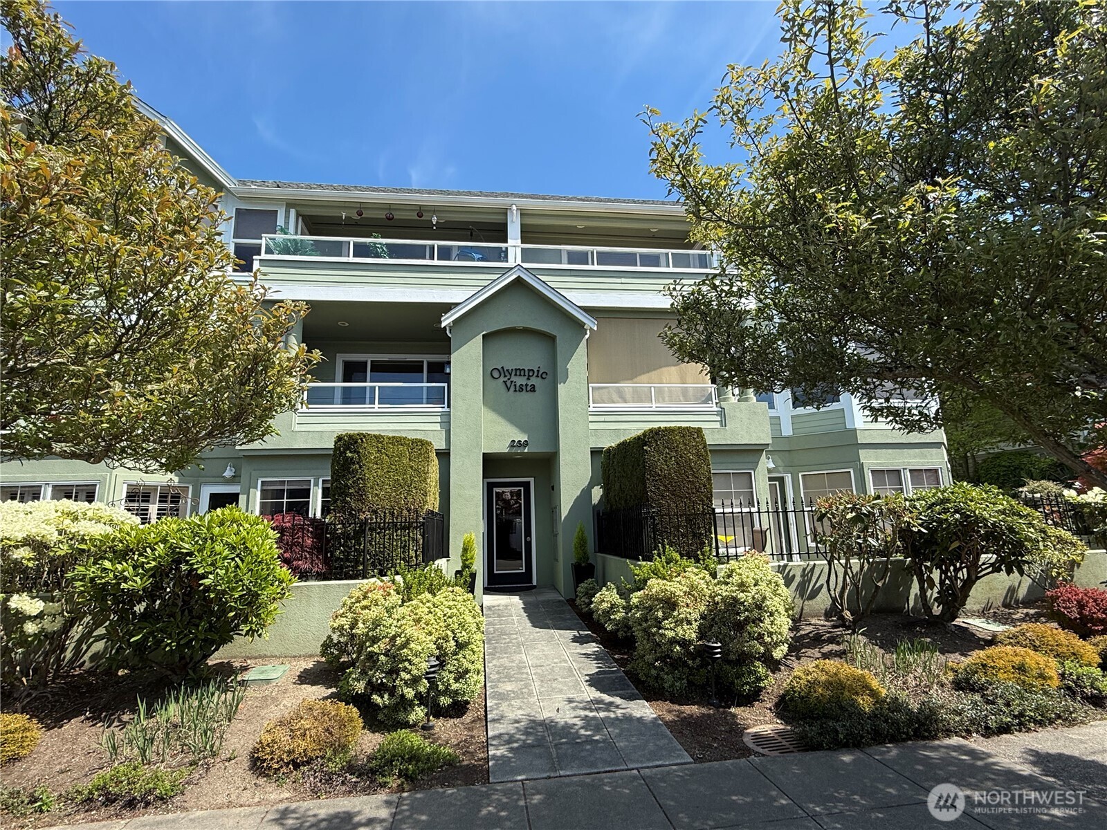 239 4th Avenue South, Unit 301 Edmonds, WA 98020 - Photo 1 of 1 a front view of a house with a yard
