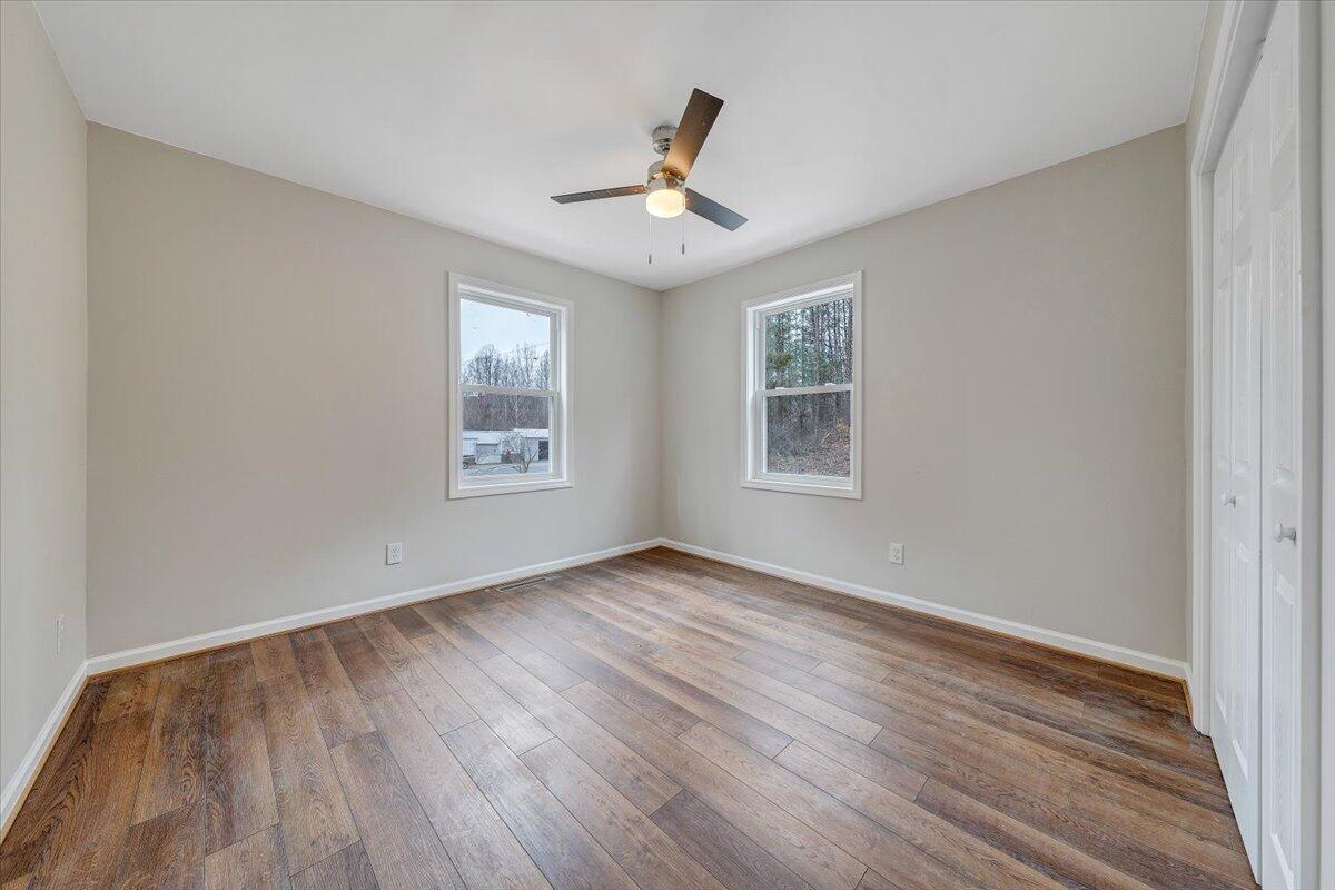 4160 Prillaman Switch Road Ferrum, VA 24088 - Photo 12 of 41 a view of an empty room with wooden floor and a window