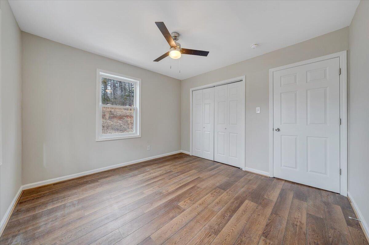 4160 Prillaman Switch Road Ferrum, VA 24088 - Photo 13 of 41 a view of an empty room with wooden floor and a window