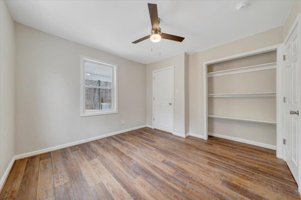 4160 Prillaman Switch Road Ferrum, VA 24088 - Photo 17 of 41 a view of empty room with wooden floor and fan