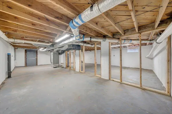 a view of large room with wooden ceiling