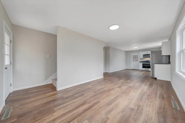 a view of kitchen and hall with wooden floor