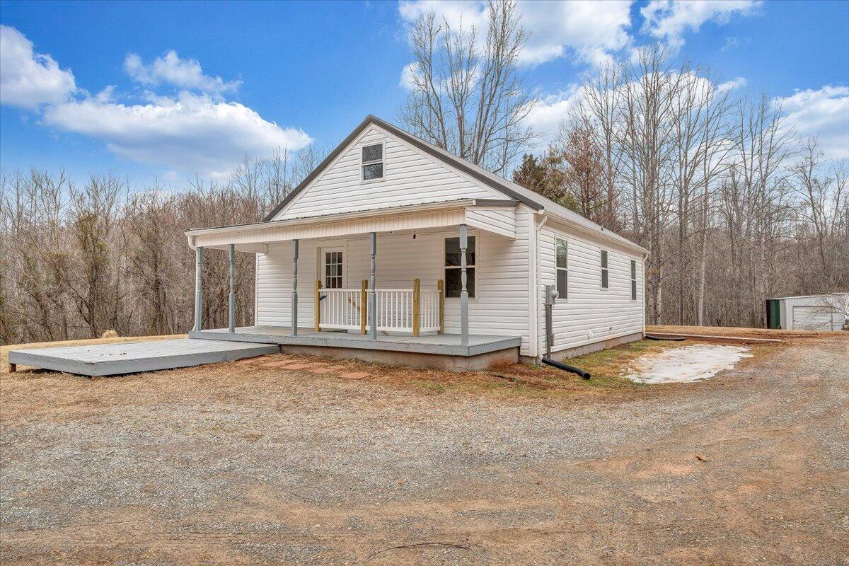 4160 Prillaman Switch Road Ferrum, VA 24088 - Photo 31 of 41 a view of a white house with a yard and large tree