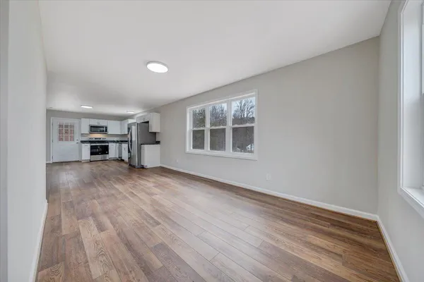 wooden floor in an empty room with a window