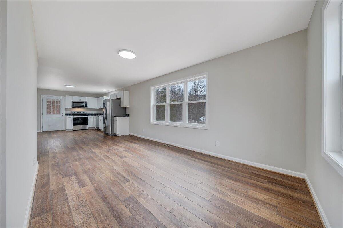 4160 Prillaman Switch Road Ferrum, VA 24088 - Photo 5 of 41 wooden floor in an empty room with a window