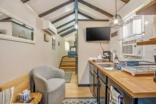 2013 Bedford Court Weatherford, TX 76087 - Photo 17 of 40 a living room with furniture a flat screen tv and kitchen view