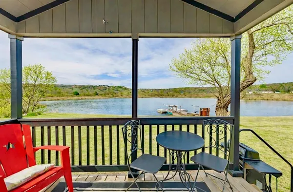 a kitchen with stainless steel appliances kitchen island granite countertop a sink dishwasher stove and microwave with wooden floor
