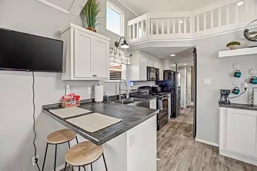2013 Bedford Court Weatherford, TX 76087 - Photo 26 of 40 a kitchen with stainless steel appliances kitchen island granite countertop a sink dishwasher stove and microwave with wooden floor