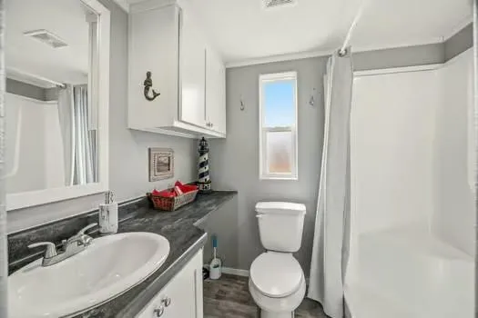 a view of a swimming pool with a lawn chairs under an umbrella