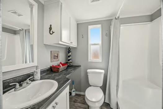 2013 Bedford Court Weatherford, TX 76087 - Photo 30 of 40 a bathroom with a granite countertop toilet sink and mirror