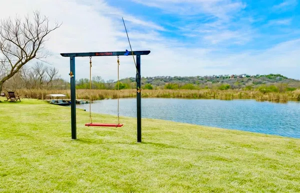 a view of a swimming pool in the backyard of a lake