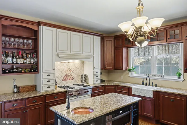 a kitchen with a stove a sink and a refrigerator