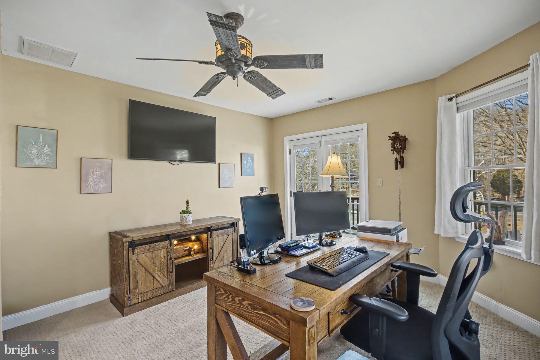 59 Byram Road Pipersville, PA 18947 - Photo 35 of 47 a view of a workspace with furniture and a flat screen tv