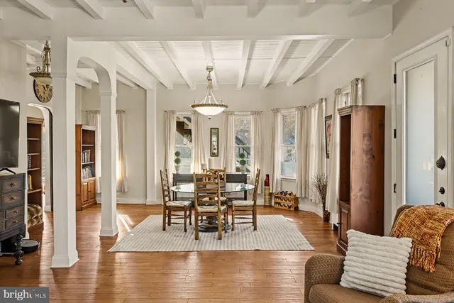 a view of a livingroom with furniture and floor to ceiling window