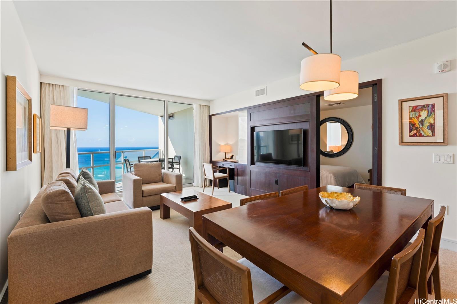 223 Saratoga Road, Unit 3208 Honolulu, HI 96815 - Photo 3 of 20 a living room with furniture a large window and a table