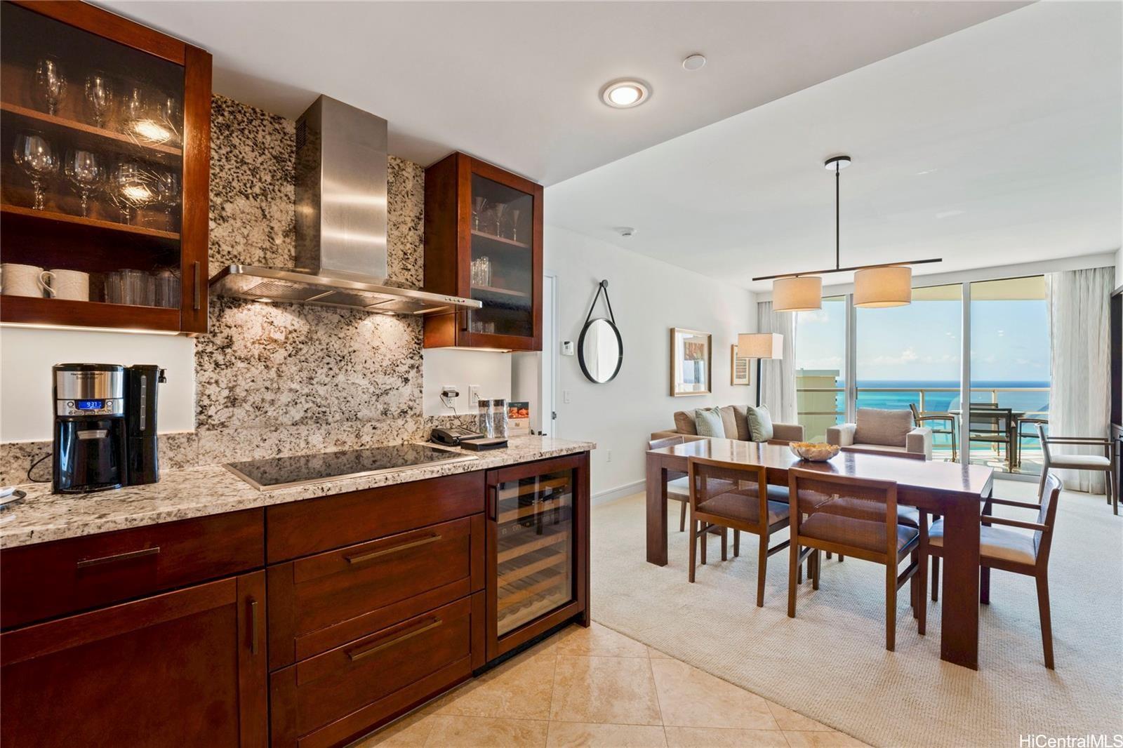 223 Saratoga Road, Unit 3208 Honolulu, HI 96815 - Photo 4 of 20 a room with lots of wooden furniture cabinets and appliances