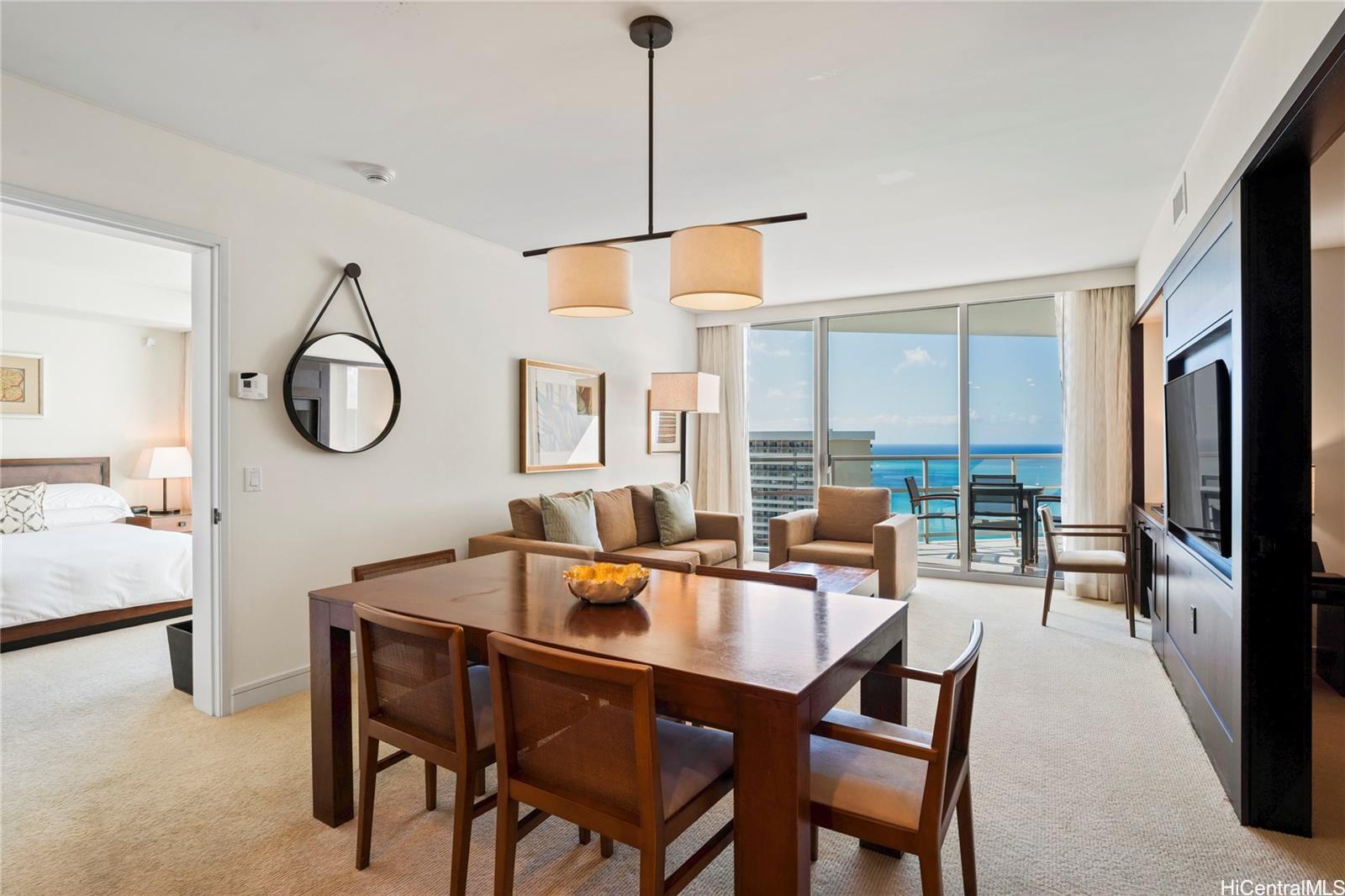 223 Saratoga Road, Unit 3208 Honolulu, HI 96815 - Photo 5 of 20 a dining room with furniture a chandelier and a rug