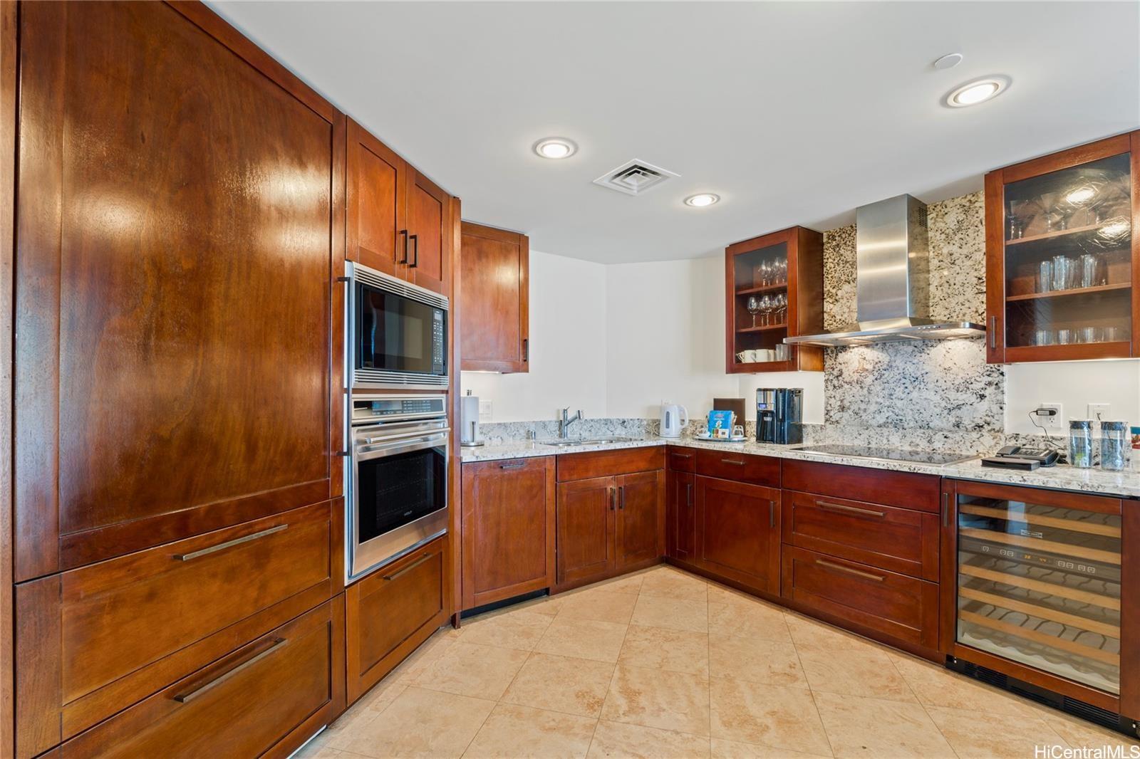 223 Saratoga Road, Unit 3208 Honolulu, HI 96815 - Photo 6 of 20 a kitchen with stainless steel appliances granite countertop a sink and cabinets