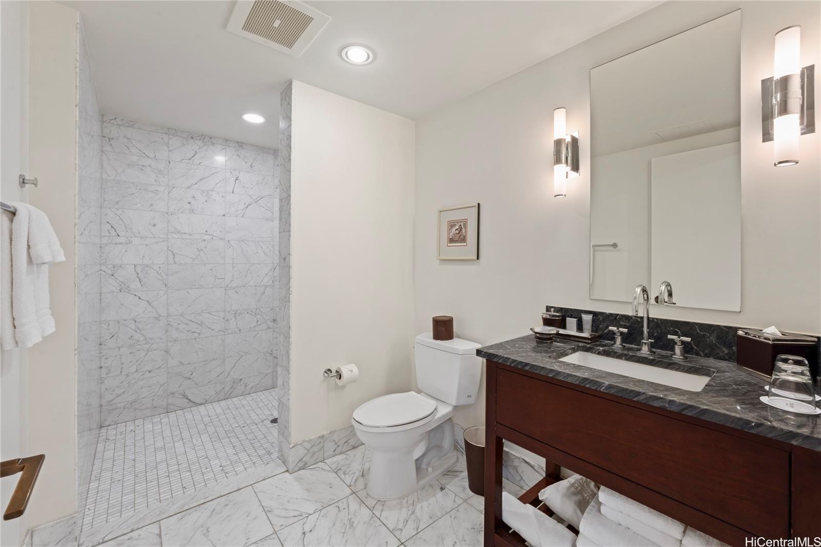 223 Saratoga Road, Unit 3208 Honolulu, HI 96815 - Photo 7 of 20 a bathroom with a double vanity sink toilet and shower