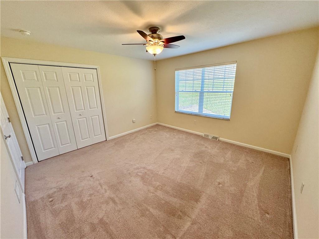 408 Chestnut Lane Apollo, PA 15613 - Photo 19 of 24 an empty room with a ceiling fan and window