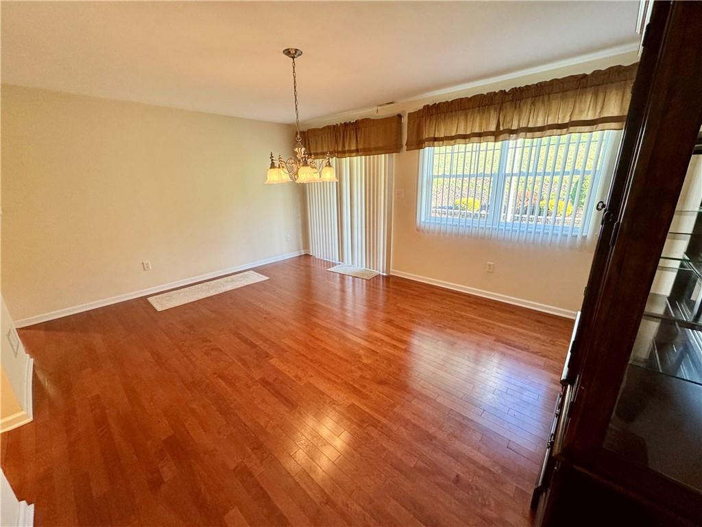 408 Chestnut Lane Apollo, PA 15613 - Photo 6 of 24 an empty room with wooden floor and windows