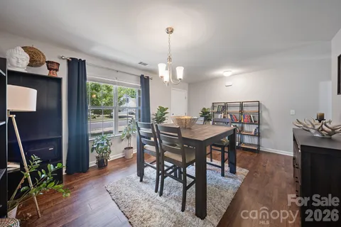 a living room with furniture a flat screen tv and a window