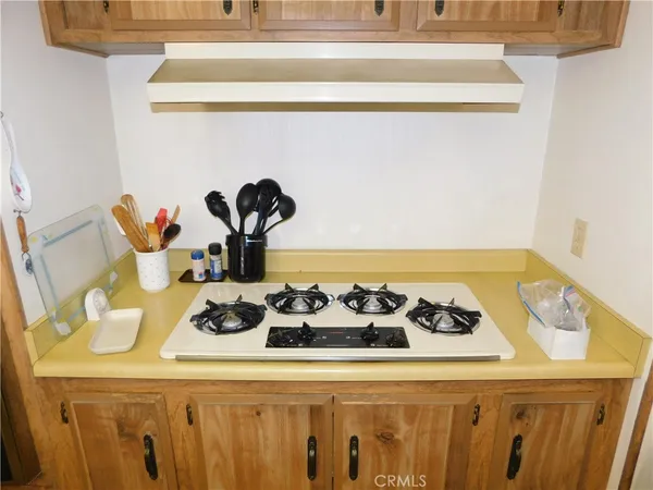a kitchen with a stove and a refrigerator
