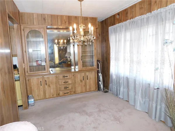 a bedroom with a bed and a chair