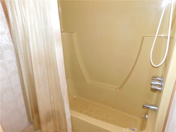a view of a closet with wooden floor