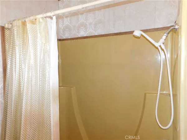 a view of a room with wooden floor and window