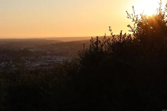 an aerial view of a house with yard and outdoor seating
